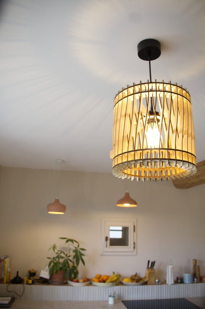 Suspension en bois Vincent l'incandescent suspendue sous une poutre en bois