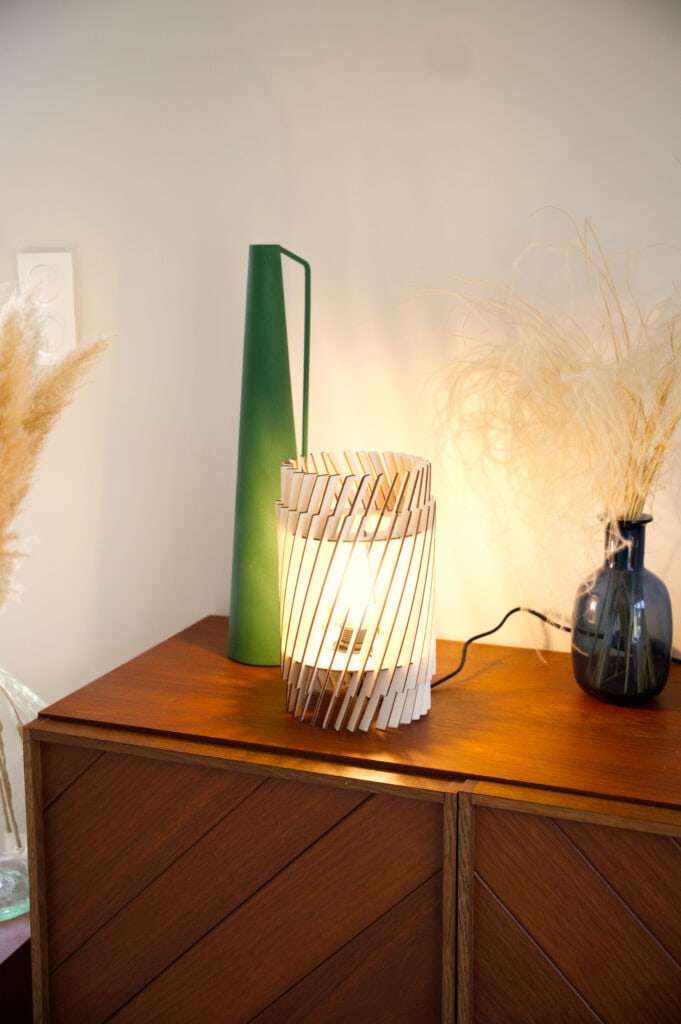 Lampe à poser bois Alice sur un buffet en bois, vases et fleurs séchées